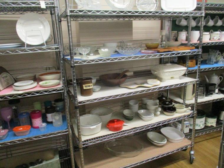 Thrift store shelves with bowls and other dishes