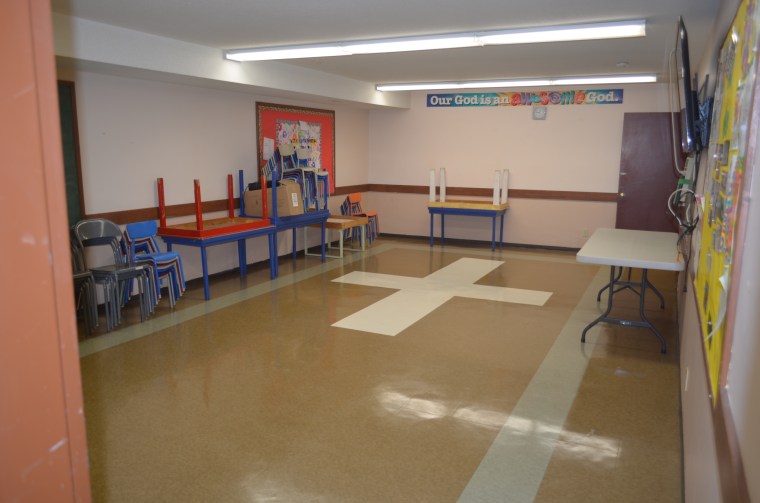 Image shows Ruth meeting room which has linoleum flooring, a chalkboard and a wall mounted big screen TV. The room also has children's and adult tables.