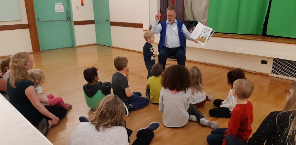 Reading Caps for Sale to a group of children