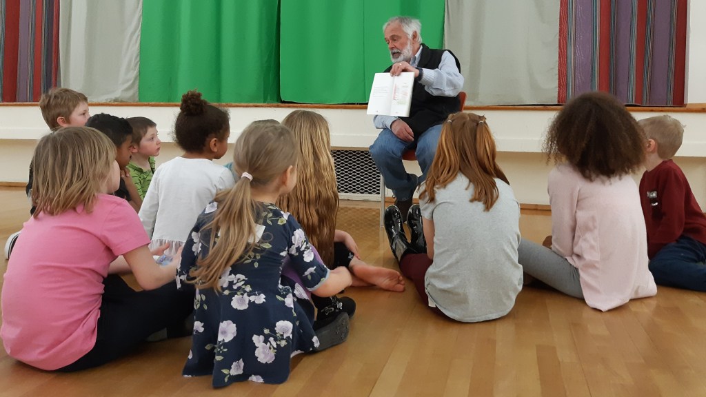 Man reading stories to children