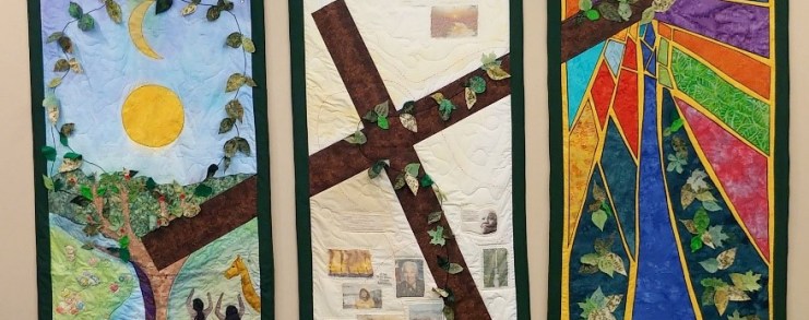 Wall hanging showing cross, Adam and Eve and stained glass.
